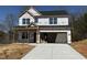 Unfinished construction shows a two-story home with a garage and newly poured driveway at 511 Valentine Ct, Graham, NC 27253