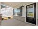 Inviting front entrance featuring a stylish black door, grey brick, and white trim, adjacent to an unfinished area at 511 Valentine Ct, Graham, NC 27253