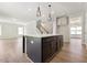 Modern kitchen featuring a center island, hardwood floors, stainless steel appliances, and ample cabinet space at 511 Valentine Ct, Graham, NC 27253