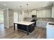 Open concept kitchen with large island, stainless appliances, and hardwood floors at 511 Valentine Ct, Graham, NC 27253