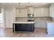 Modern kitchen offers stainless appliances, subway tile backsplash, and center island at 511 Valentine Ct, Graham, NC 27253