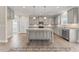 Open kitchen with granite countertops, an island, stainless steel appliances, and gray cabinets at 511 Valentine Ct, Graham, NC 27253