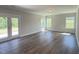 Spacious living room with hardwood floors, bright windows, and French doors to the yard at 511 Valentine Ct, Graham, NC 27253
