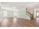 Inviting living room with hardwood floors, neutral walls, white trim, and a staircase, bathed in natural light at 511 Valentine Ct, Graham, NC 27253