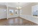 Bright living room with hardwood floors, white wainscoting, and large windows at 511 Valentine Ct, Graham, NC 27253