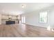 Bright living room with an open layout, hardwood floors, white trim, and a view into the kitchen at 511 Valentine Ct, Graham, NC 27253