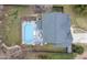 Backyard with an in-ground swimming pool, a spacious deck with furniture, surrounded by green grass and a gray roof at 512 Tryst Ln, Wake Forest, NC 27587