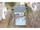 Backyard featuring a swimming pool, deck area with outdoor furniture, all surrounded by lush greenery, with mature trees at 512 Tryst Ln, Wake Forest, NC 27587