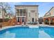 Exterior of home with in-ground pool, deck, patio, and a screened-in porch provides indoor-outdoor flow at 512 Tryst Ln, Wake Forest, NC 27587