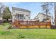 Backyard with deck, in-ground pool, and covered porch creates a perfect space for outdoor living and entertaining at 512 Tryst Ln, Wake Forest, NC 27587
