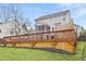 Exterior of home features a large deck, in-ground pool, and well-maintained yard offers great outdoor living at 512 Tryst Ln, Wake Forest, NC 27587