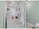 Modern bathroom shower with a glass door, tiled walls, and convenient shelving at 512 Tryst Ln, Wake Forest, NC 27587