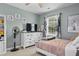 Cozy bedroom with bright window, white dresser, TV, fan, and a comfortable twin bed at 512 Tryst Ln, Wake Forest, NC 27587