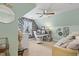 A quaint bedroom featuring a stylish desk, daybed, and soothing mint green walls at 512 Tryst Ln, Wake Forest, NC 27587