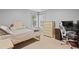 Bedroom with two windows, twin bed, dresser, and desk, providing a comfortable and functional space at 512 Tryst Ln, Wake Forest, NC 27587