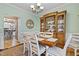 Elegant dining room with decorative chandelier, wooden hutch, and seating for eight at 512 Tryst Ln, Wake Forest, NC 27587