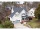 Aerial view of a two-story home featuring a garage, porch, well-maintained landscaping and mature trees at 512 Tryst Ln, Wake Forest, NC 27587