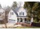 Charming two-story home with a welcoming front porch, a garage, and nicely landscaped front yard at 512 Tryst Ln, Wake Forest, NC 27587
