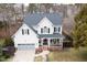 Charming two-story home with a welcoming front porch, garage, and well-maintained landscaping at 512 Tryst Ln, Wake Forest, NC 27587