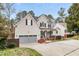 Charming two-story home with a welcoming front porch, garage, and nicely landscaped front yard at 512 Tryst Ln, Wake Forest, NC 27587
