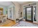 Stylish foyer with decorative rug, adjacent dining area, and sidelight windows around the front door at 512 Tryst Ln, Wake Forest, NC 27587