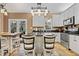 Well-lit kitchen featuring a large island, white cabinets, granite countertops, and stainless steel appliances at 512 Tryst Ln, Wake Forest, NC 27587