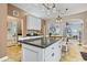 Open kitchen with island, white cabinets, granite counters, and view to living area at 512 Tryst Ln, Wake Forest, NC 27587