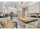 Eat-in kitchen features white cabinets, stainless appliances, and granite countertops at 512 Tryst Ln, Wake Forest, NC 27587