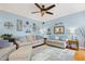 Cozy living room with hardwood floors, ceiling fan and serene light blue walls at 512 Tryst Ln, Wake Forest, NC 27587