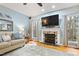 Living room with hardwood floors, fireplace and windows allowing ample natural light at 512 Tryst Ln, Wake Forest, NC 27587