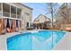 Backyard oasis with in-ground pool, lounge chairs, and screened porch view provides a relaxing space at 512 Tryst Ln, Wake Forest, NC 27587