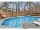 Backyard featuring an in-ground pool surrounded by a deck offers a private and relaxing oasis at 512 Tryst Ln, Wake Forest, NC 27587