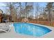 Backyard with a beautiful in-ground pool surrounded by a deck offers a space for outdoor enjoyment at 512 Tryst Ln, Wake Forest, NC 27587
