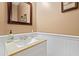 Powder room with wainscotting, decorative mirror, and stylish fixtures at 512 Tryst Ln, Wake Forest, NC 27587