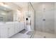 Beautiful bathroom with dual vanity sinks, glass shower, and neutral tile at 560 Waterstone Ln, Henderson, NC 27537