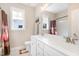Well-lit bathroom featuring a double vanity, large mirror, and neutral color palette creating a serene and functional space at 560 Waterstone Ln, Henderson, NC 27537