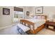 Inviting bedroom with a bed, bench, natural light, and simple, elegant decor at 560 Waterstone Ln, Henderson, NC 27537