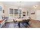 Bright dining area with a modern chandelier, large windows, and comfortable seating for Gathering gatherings at 560 Waterstone Ln, Henderson, NC 27537