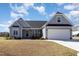 Beautiful single-Gathering home with a manicured lawn, and two-car garage, providing curb appeal at 560 Waterstone Ln, Henderson, NC 27537