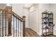 Hallway with wood floors, staircase, and shelving, creating an organized and stylish space at 560 Waterstone Ln, Henderson, NC 27537
