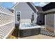 Backyard featuring a hot tub with a cover surrounded by a white lattice fence and gray siding creating privacy at 560 Waterstone Ln, Henderson, NC 27537