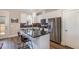Bright kitchen with stainless steel appliances, black countertops, and a stylish island with seating at 560 Waterstone Ln, Henderson, NC 27537