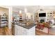 Open floor plan features a spacious living room with a fireplace and a dining area with natural light at 560 Waterstone Ln, Henderson, NC 27537