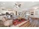 Open living area with a comfortable sofa, ceiling fan, and kitchen view, perfect for entertaining at 560 Waterstone Ln, Henderson, NC 27537