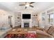 Cozy living room with a fireplace, built-in shelving, and large windows for natural light at 560 Waterstone Ln, Henderson, NC 27537