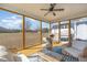 Inviting screened porch with comfortable seating, a ceiling fan, and scenic views for relaxation and entertaining at 560 Waterstone Ln, Henderson, NC 27537