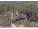 Remote house with red roof, fenced yard and outbuilding amidst lush trees at 577 Dixon Rd # D, Willow Springs, NC 27592
