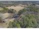 Expansive aerial shot of private, wooded land with scattered homes, perfect for building a secluded estate at 577 Dixon Rd # D, Willow Springs, NC 27592