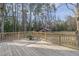 Exterior shot of a wooden deck that looks out into the backyard with a utility building at 577 Dixon Rd # D, Willow Springs, NC 27592
