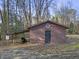 Exterior view of a brown barn featuring a decorative quilt square and covered parking for equipment at 577 Dixon Rd # D, Willow Springs, NC 27592
